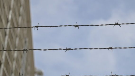 Wire on top of fence