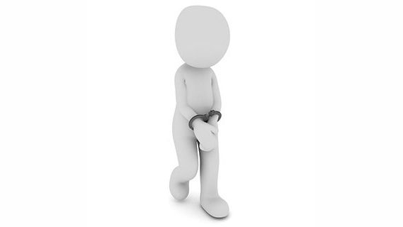 Figure handcuffed