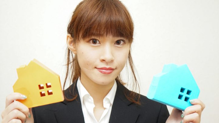 Asian woman holding property
