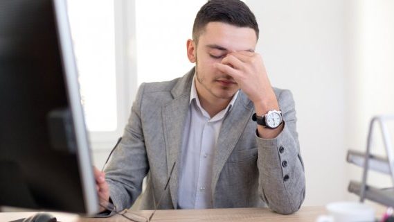Male employee stressed at work