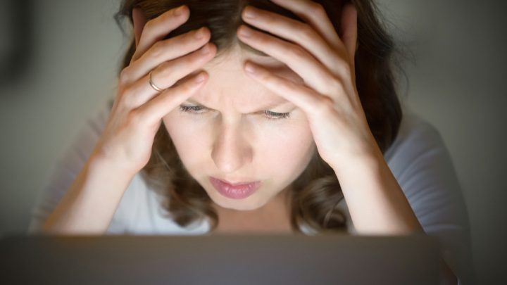 Stressed woman on laptop