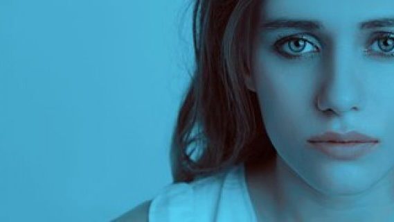 Sad lady in a gloomy blue room
