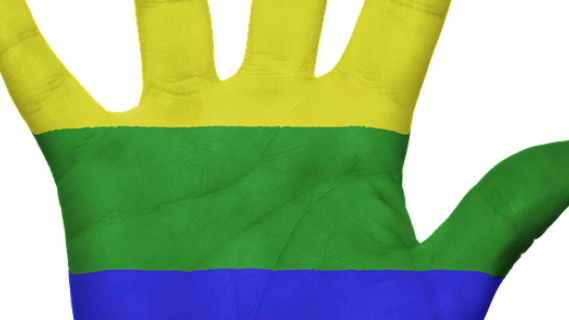 Gay flag painted on a hand